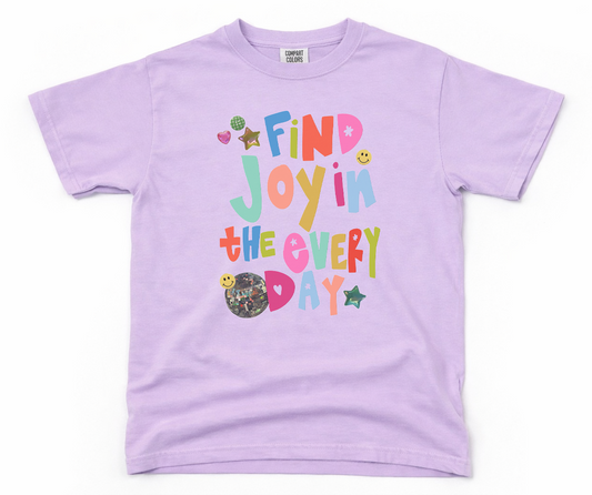 Lavender t-shirt with colorful text 'Find Joy in the Every Day' on a white background