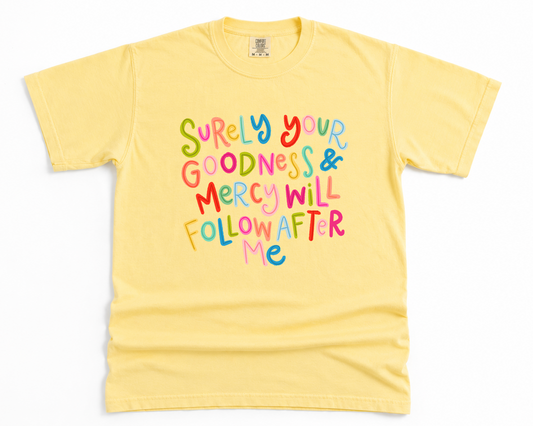 Yellow t-shirt with colorful text on a white background