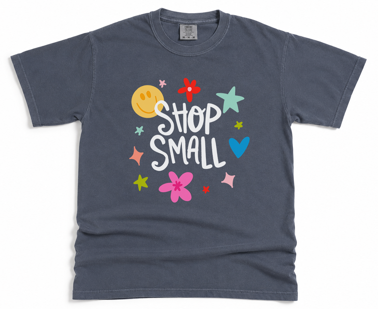 Gray t-shirt with colorful graphics and 'Shop Small' text on a white background