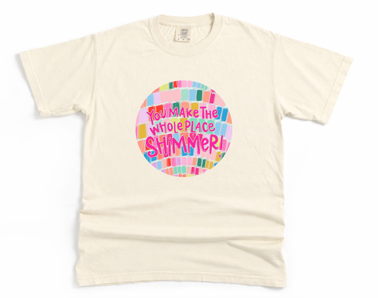 Beige t-shirt with colorful graphic and text on a white background