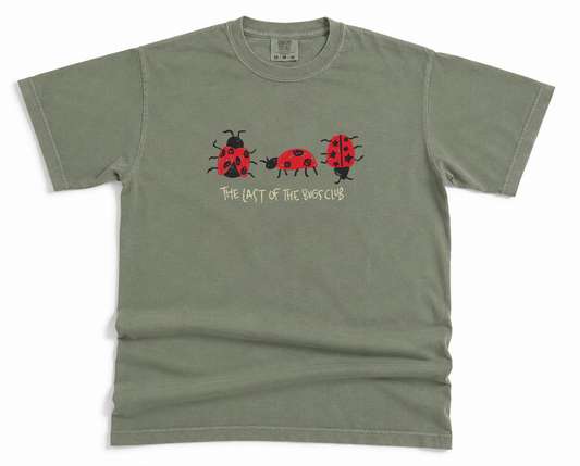 Green t-shirt with ladybug design and The Last of the bugs club text on a white background