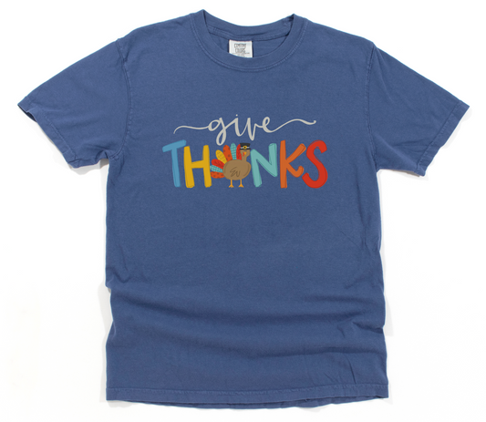 Blue t-shirt with 'give THANKS' text and a turkey graphic on a white background