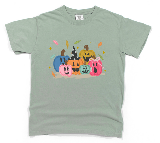 Light green t-shirt with colorful pumpkin design on a white background