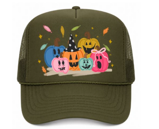 Green trucker hat with Halloween-themed design of colorful pumpkins on a white background