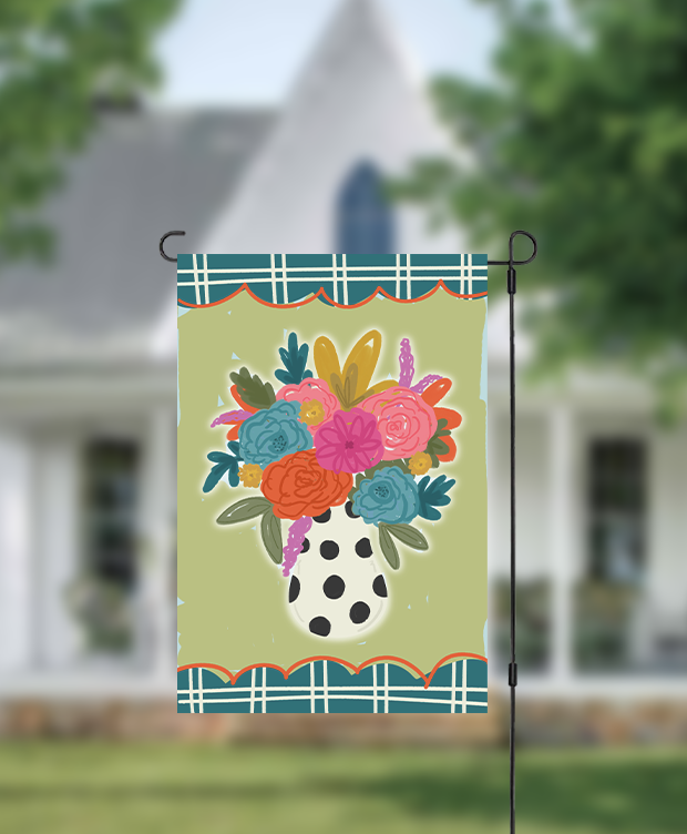 Colorful vase of flowers on a garden flag in front of a house