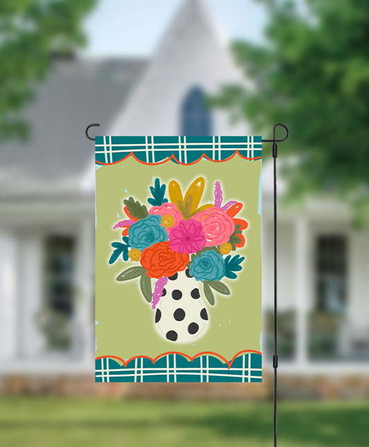 Colorful vase of flowers on a garden flag in front of a house