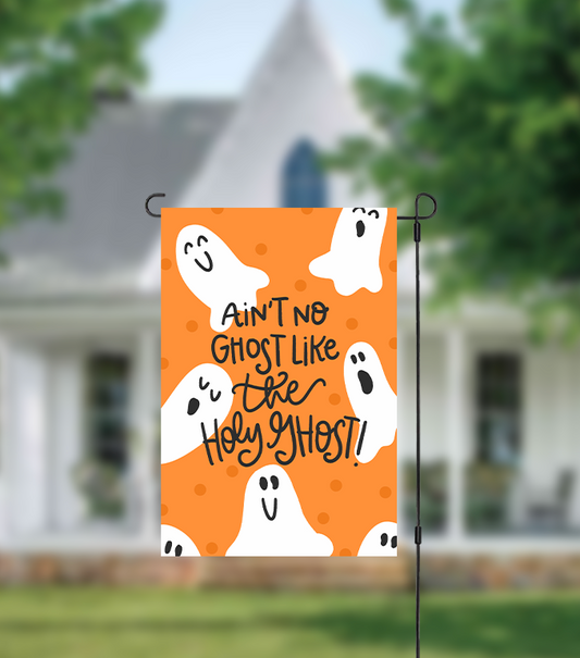 Halloween-themed garden flag with ghosts and text in front of a house reading "ain't no ghost like the holy ghost"