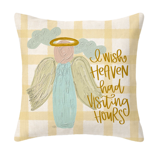 Decorative pillow with angel illustration and text on a checkered background