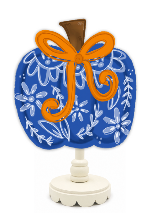 Decorative item with blue floral pattern, orange bow, and white base on a white background