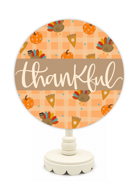 Decorative sign with 'thankful' text and Thanksgiving-themed illustrations on a white background