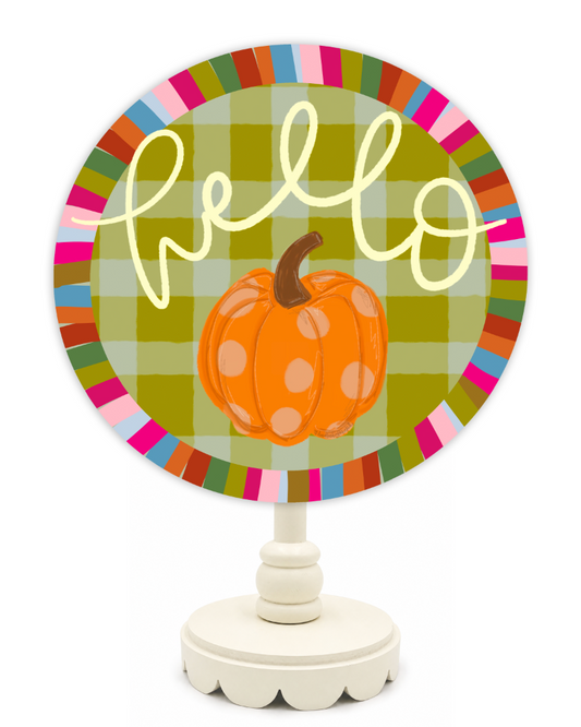 Decorative sign with a pumpkin and 'hello' text on a colorful plaid background