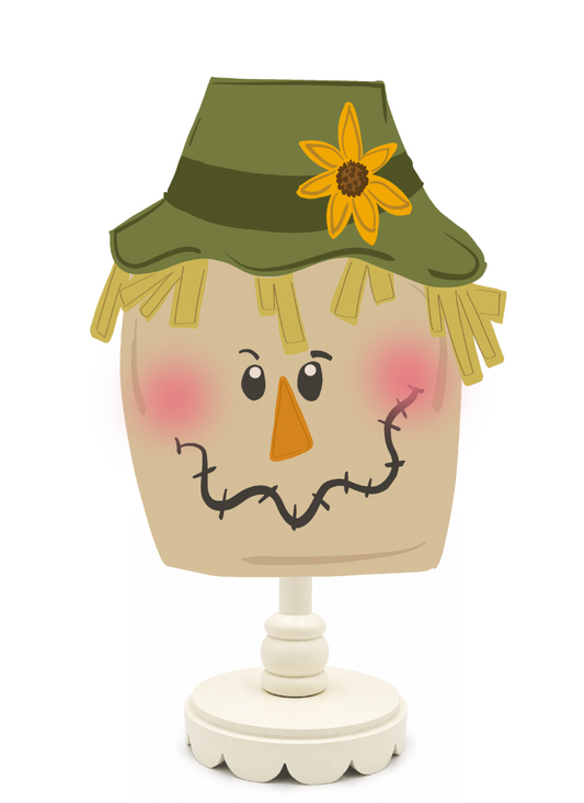 Decorative scarecrow figure with a green hat and sunflower on a white background