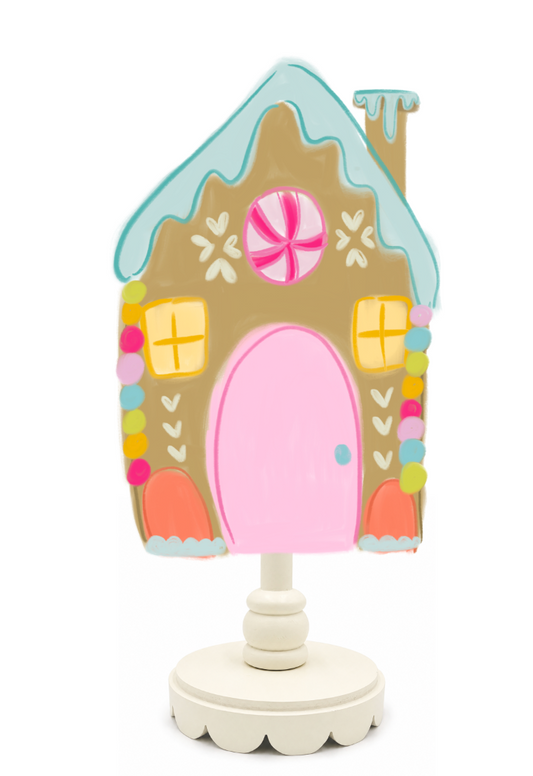 Decorative gingerbread house-shaped lamp on a white background