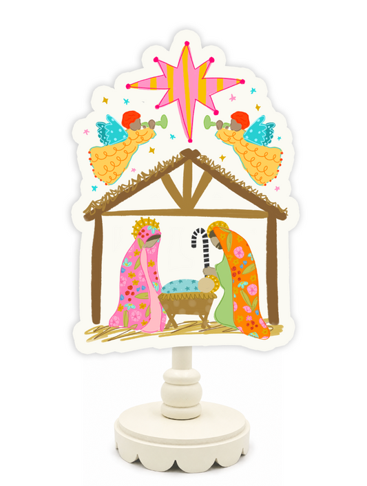Decorative nativity scene with colorful figures and a star on a white background