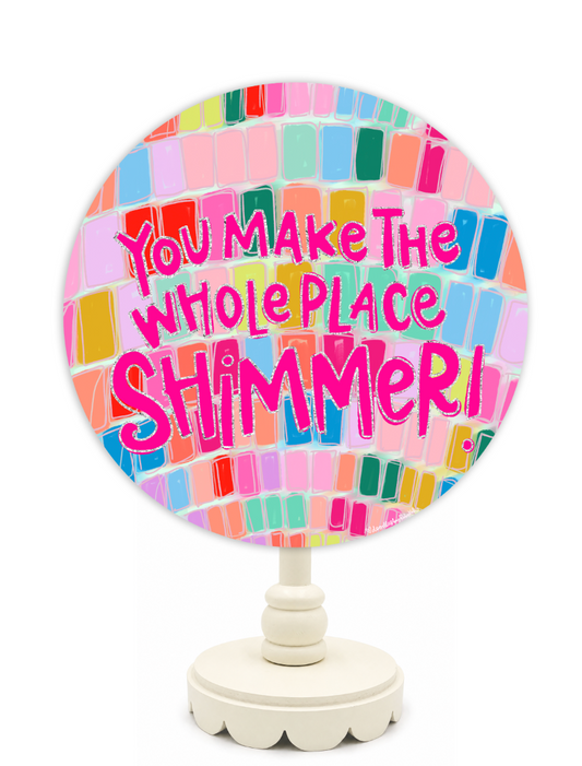 Decorative mirror with colorful mosaic design and text on a white background