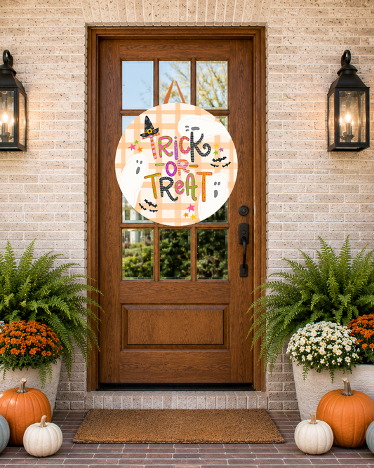 Front door with a 'Trick or Treat' sign, surrounded by pumpkins and plants on a brick porch.