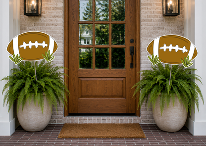 Decorative football signs with plants on either side of a wooden door.