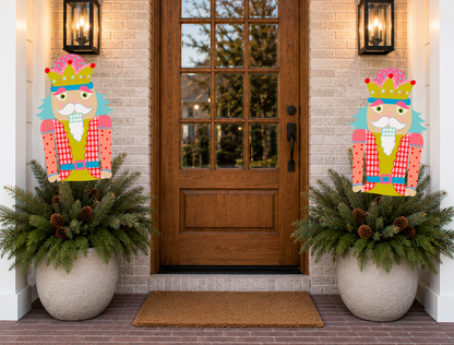 Decorative nutcrackers flanking a door with festive planters.