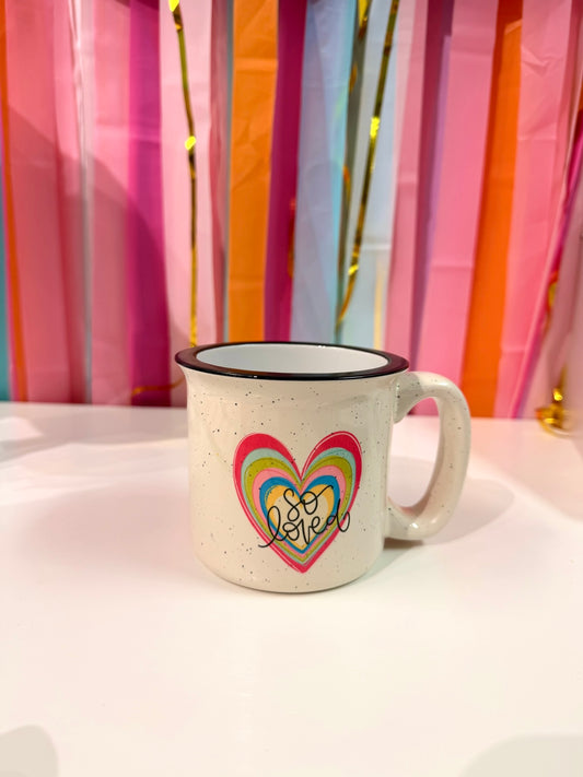 Doodles by Rebekah "So Loved" heart campfire mug featuring a colorful, hand-painted layered heart design. This whimsical ceramic coffee cup makes a thoughtful Valentine's Day gift, birthday present, or a sweet daily reminder of being loved.