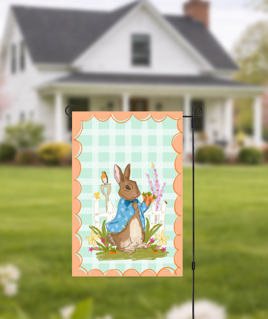 Doodles by Rebekah "Peter Rabbit" inspired garden flag featuring a whimsical hand-painted bunny in a blue coat and a teal checkered pattern. This charming spring and Easter outdoor decor is perfect for front yards, gardens, or seasonal porch displays.