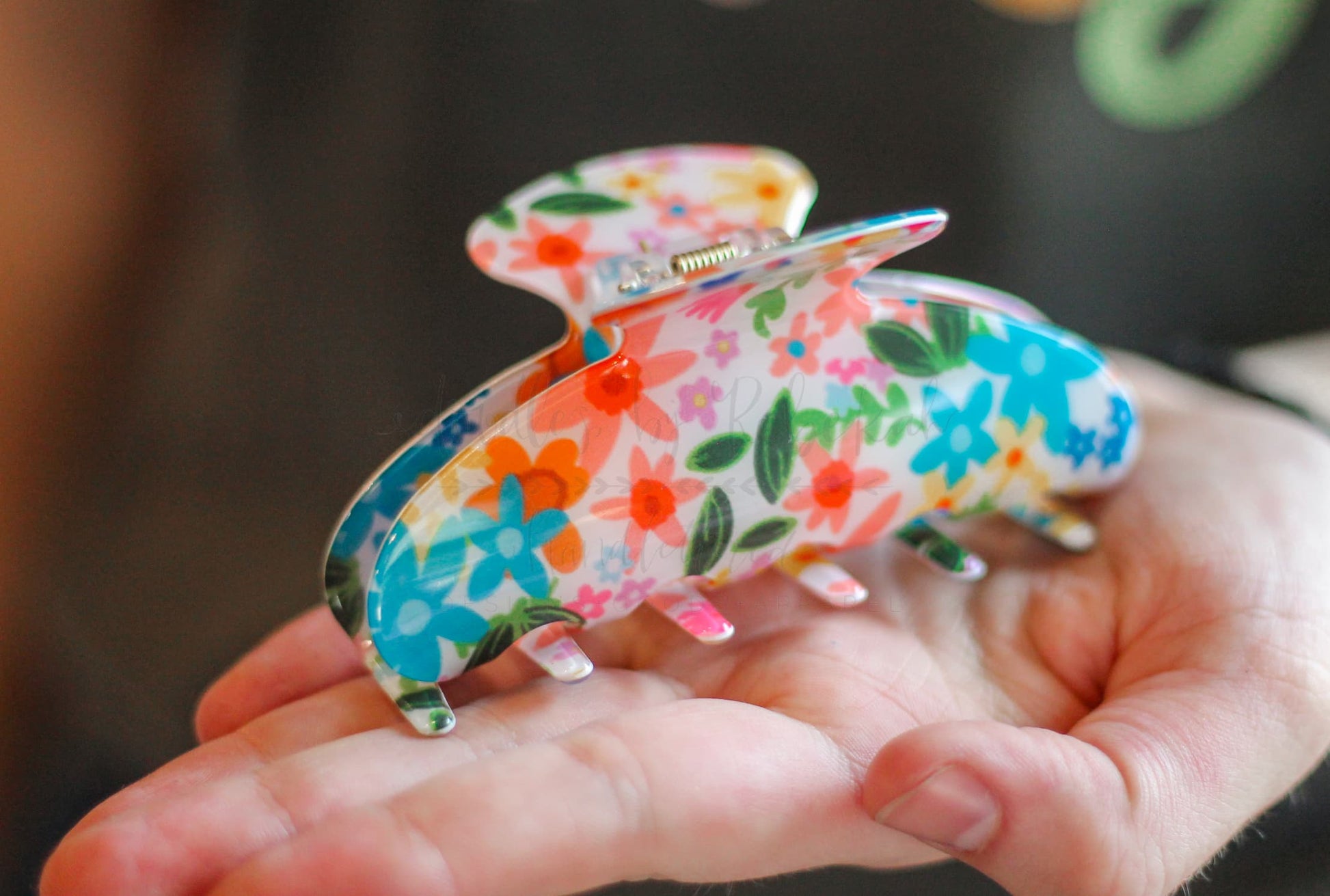 Doodles by Rebekah floral hair claw clip with colorful hand-drawn retro flowers on a neutral base.