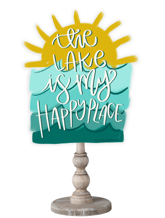 Doodles by Rebekah lake house tabletop decor with sun and wave illustration and "the lake is my happy place" hand-lettering.