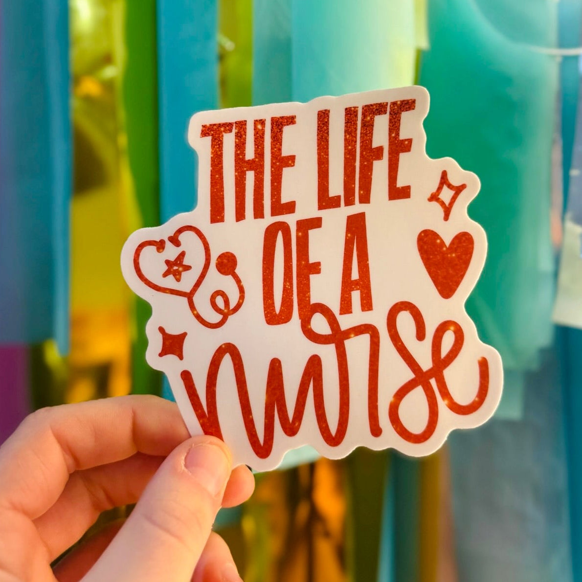 Doodles by Rebekah "The Life of a Nurse" burnt orange glitter sticker. This hand-painted medical-themed vinyl decal is a perfect gift for nursing students, RNs, and healthcare workers to decorate water bottles, clipboards, and planners.