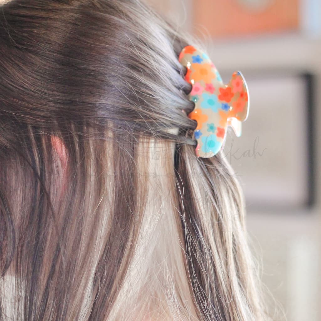 Patterned acetate hair claw clip for women featuring a bright summer floral design and sturdy grip.