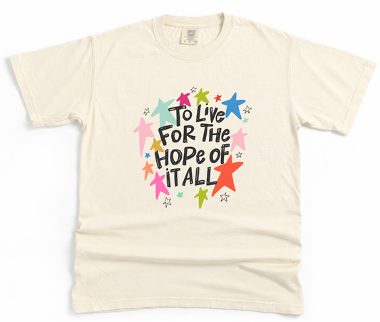 Beige t-shirt with colorful graphic and text on a white background