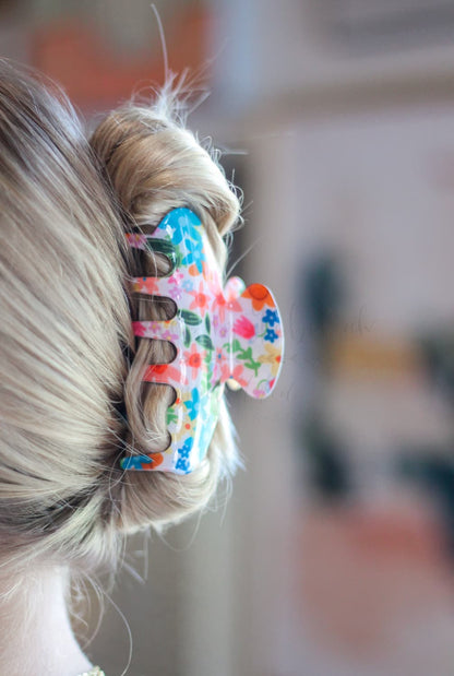 Patterned acetate hair claw clip for women featuring a bright summer floral design and sturdy grip.
