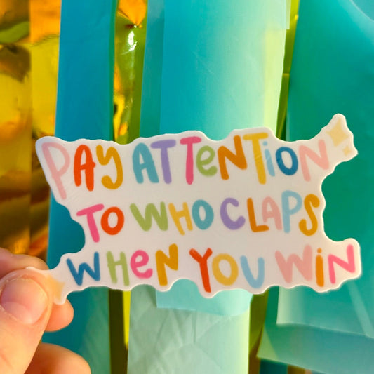 Doodles by Rebekah "Pay Attention to Who Claps When You Win" motivational vinyl sticker. This colorful, hand-painted inspirational quote decal is a perfect gift for friends and entrepreneurs to decorate water bottles, laptops, and journals.