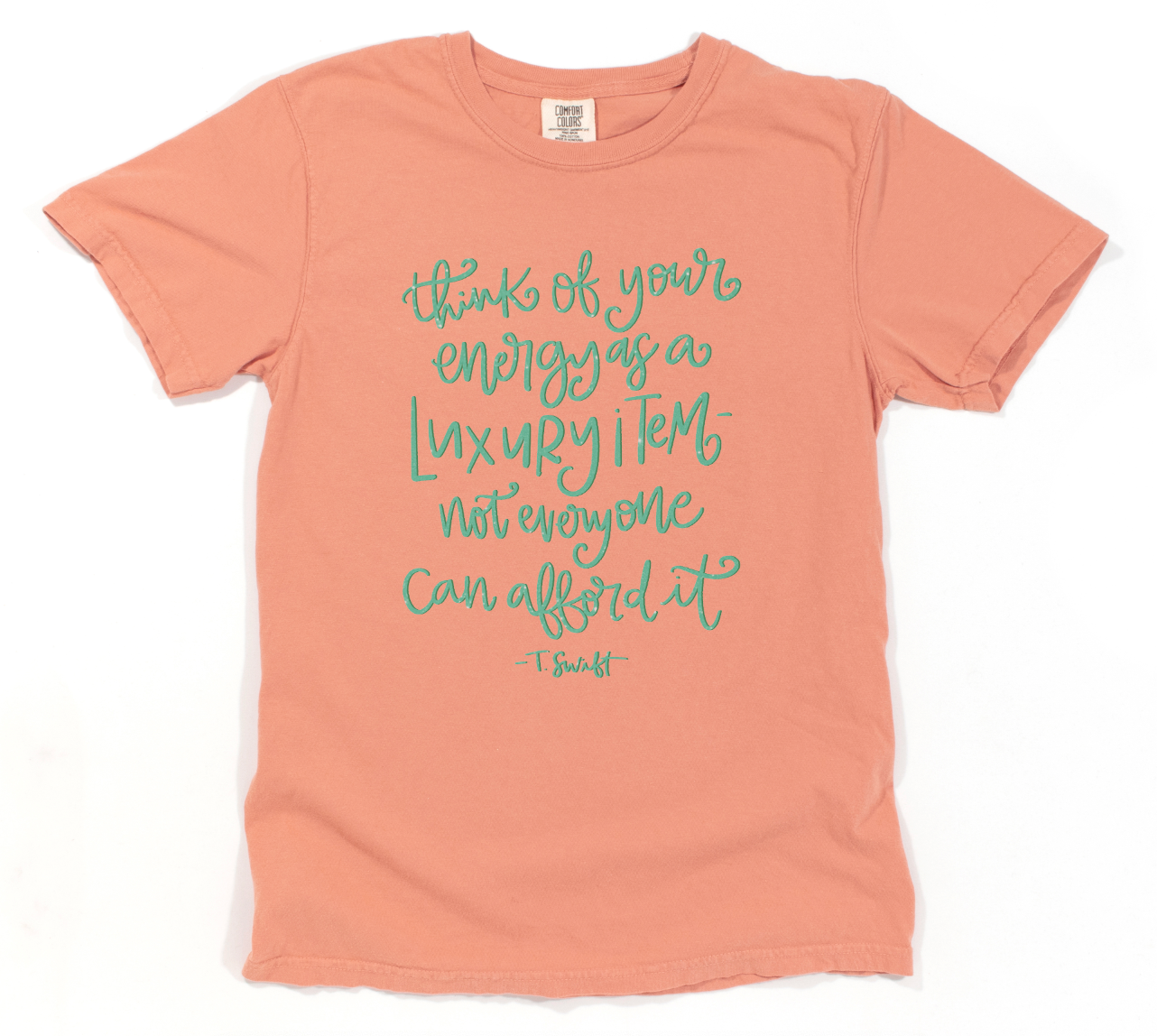 Pink t-shirt with teal text on a white background