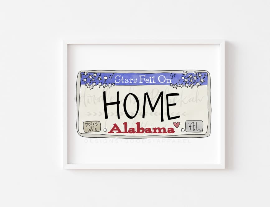 a framed print with an Alabama license plate design that reads "Home"