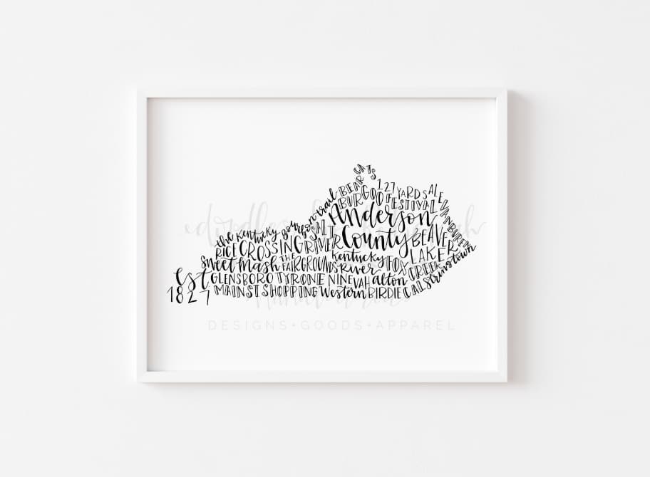 Framed white print of Anderson County on a white wall