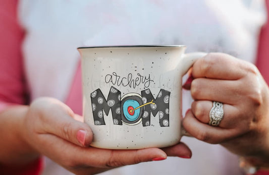 Close up of a person holding a coffee mug with archery mom design