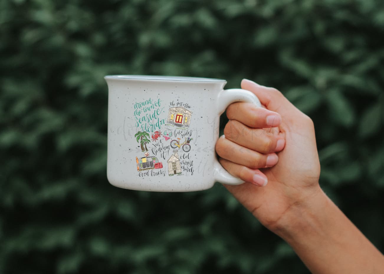 Close up of a white coffee mug with items describing Florida seaside