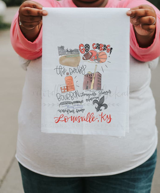 A person holding a white polyester tea towel with red and black printed text and graphics representing Louisville, KY.