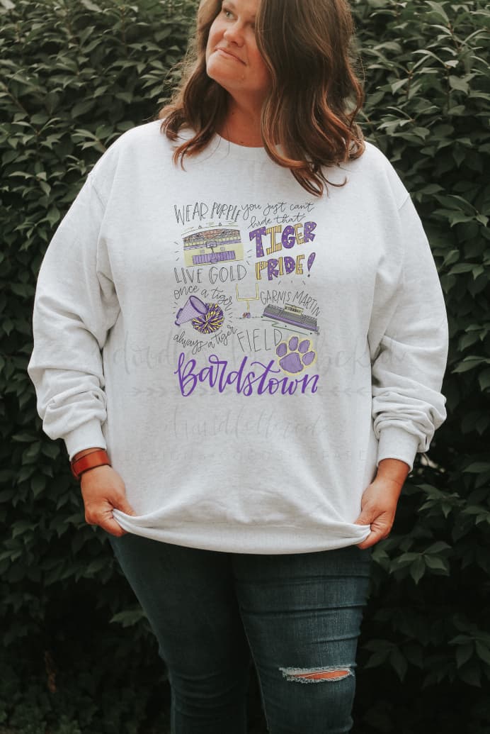 Person wearing a sweatshirt with doodles of Bardstown Tiger team pride