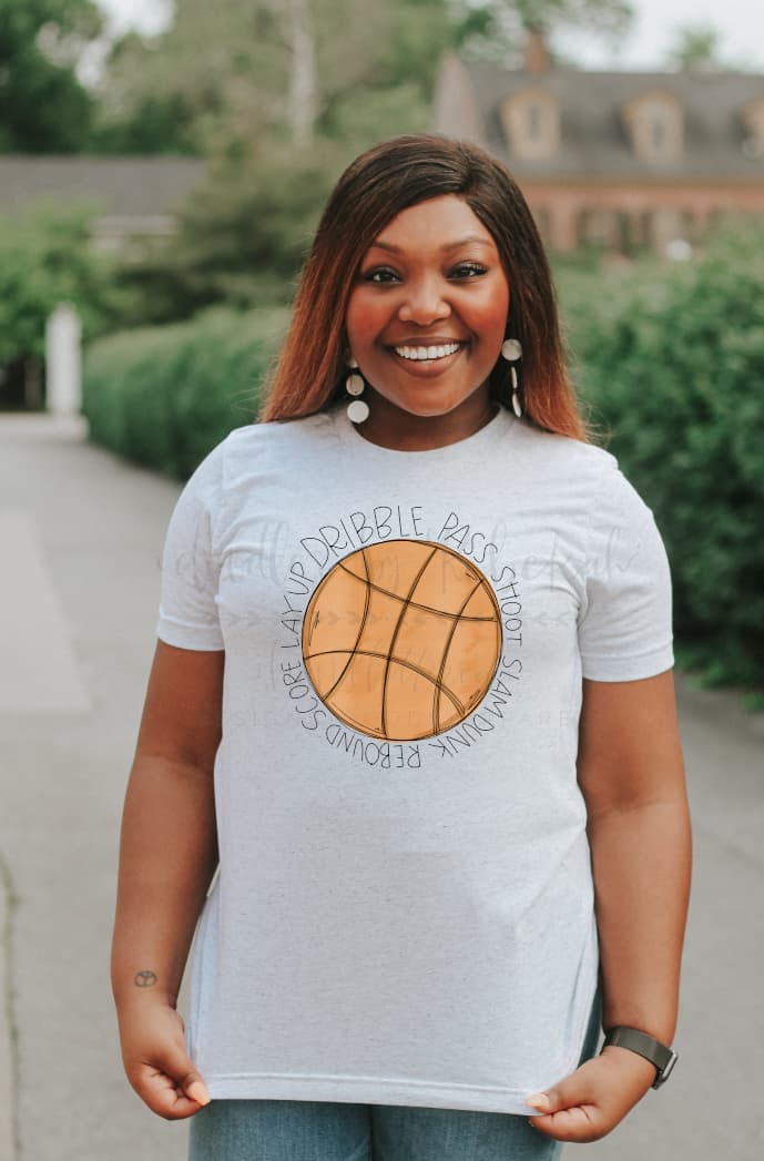 Woman wearing a white t-shirt with a basketball graphic