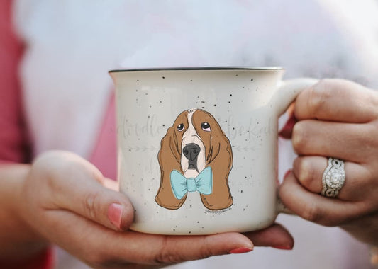 A ceramic mug with a single-sided print of a basset hound wearing a bow tie.