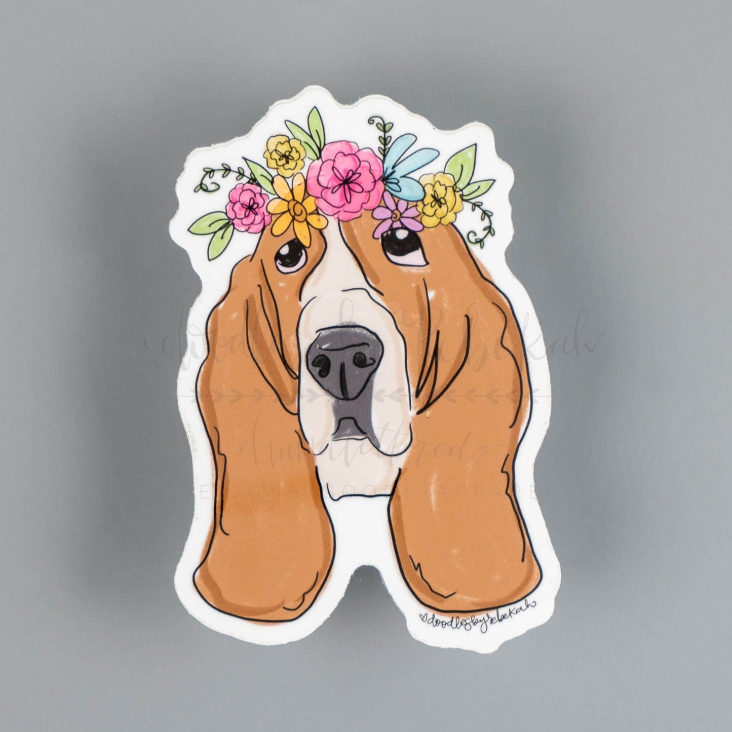 A sticker depicting a Basset Hound dog with a floral crown design.