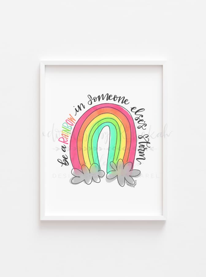 Framed drawing with a doodle of "be a rainbow in someone else's storm"