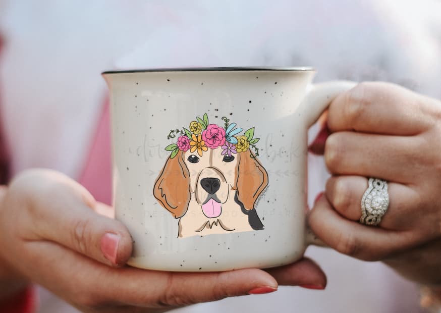 person holding a coffee mug with a graphic of a female beagle with a flower crown