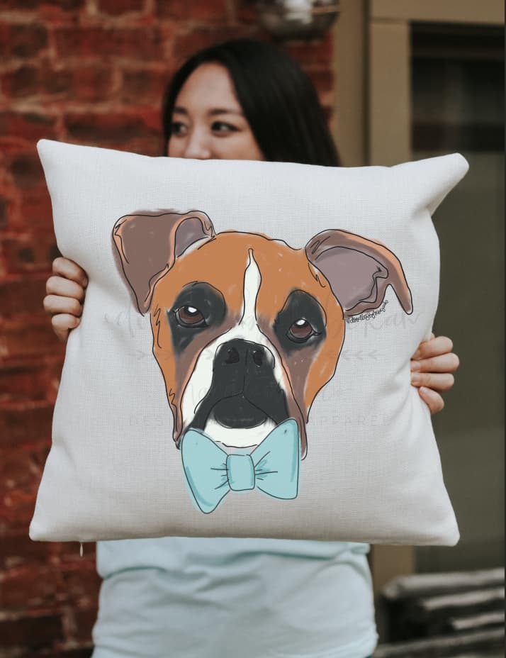 A square pillow with a whimsical drawing of a boxer dog with a bowtie
