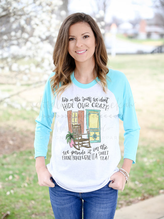 A woman wearing a long-sleeved blue sweatshirt with white text and graphics, standing outdoors.