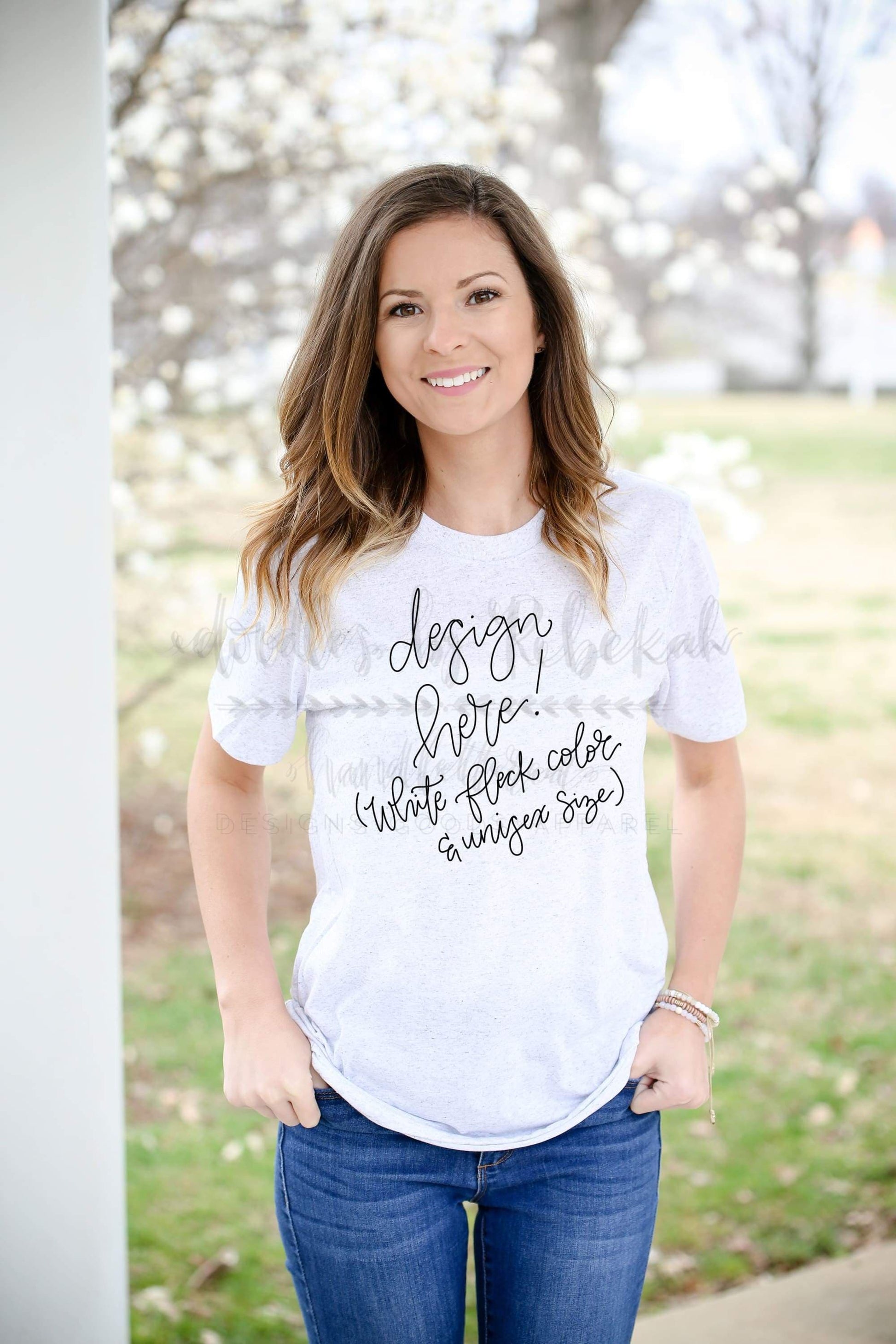 a woman with a white tee that says "design here!" showing the shirt can be customized. 
